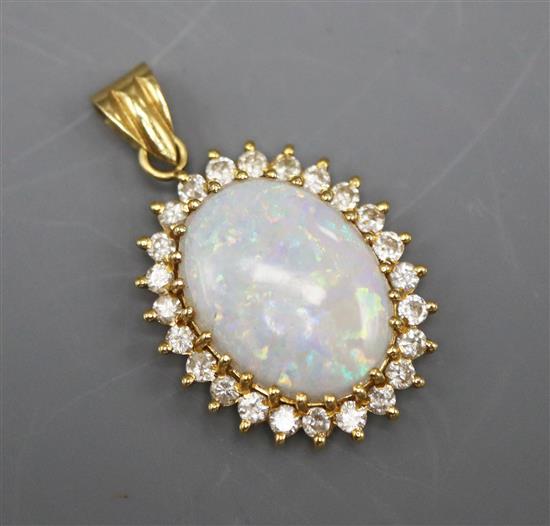 An opal and diamond cluster pendant in yellow metal claw setting (tests as 18ct), 24mm.